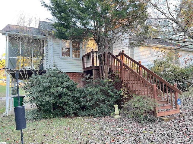 view of side of home featuring a sunroom