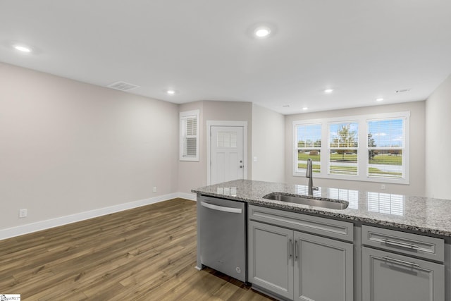 kitchen with dishwasher, sink, gray cabinets, light stone countertops, and dark hardwood / wood-style flooring