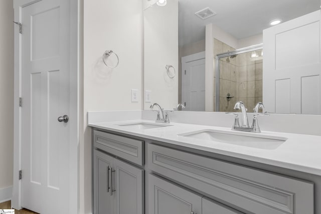 bathroom featuring vanity and a shower with door