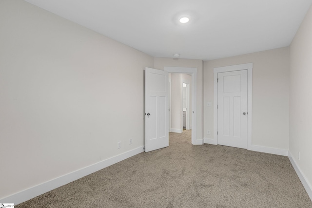 unfurnished bedroom with carpet flooring and a closet