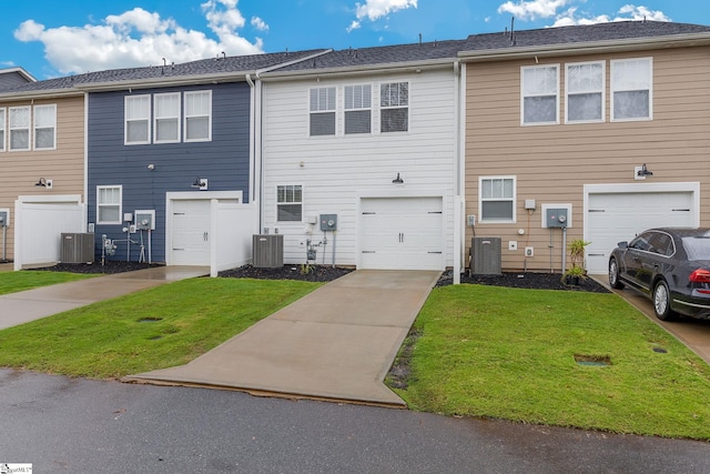 rear view of property featuring central AC and a lawn