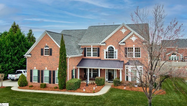 view of front property featuring a porch and a front yard