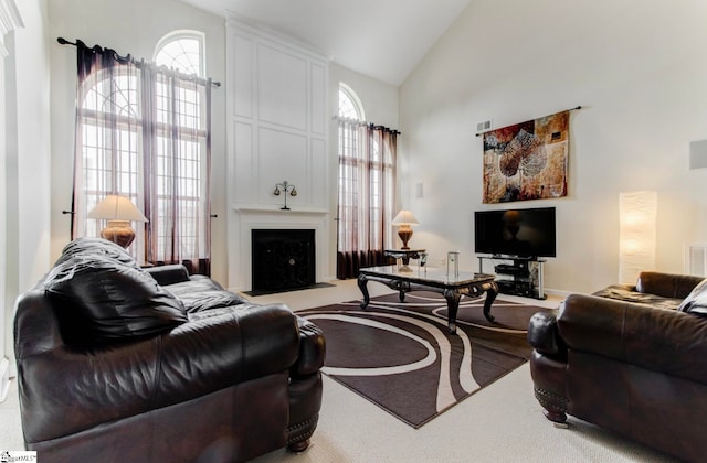 carpeted living room with high vaulted ceiling