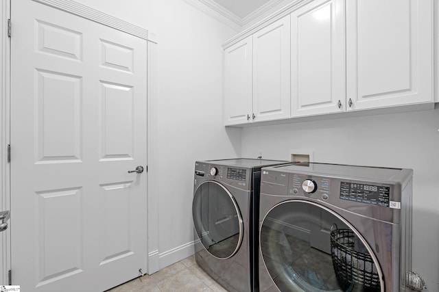 laundry room featuring cabinets, light tile patterned floors, separate washer and dryer, and crown molding