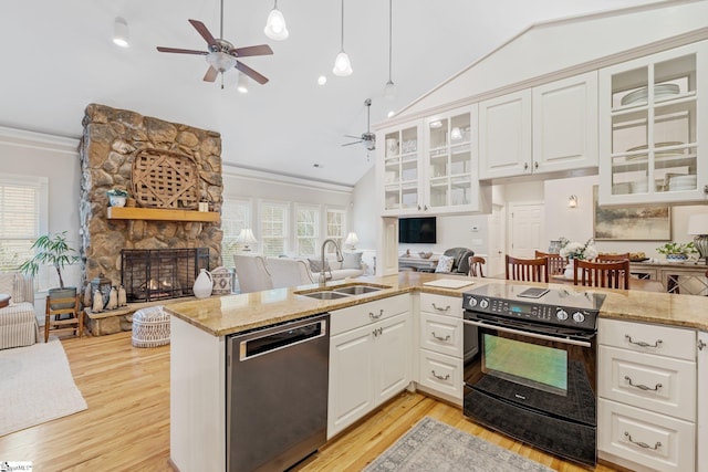 kitchen with stainless steel dishwasher, white cabinets, black range with electric stovetop, and sink