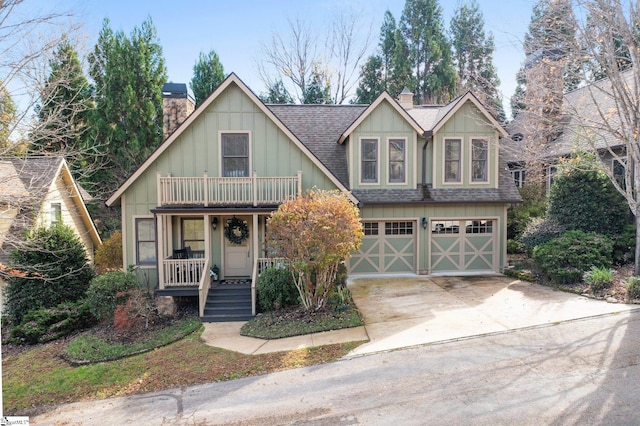 view of front of home with a porch, a garage, and a balcony