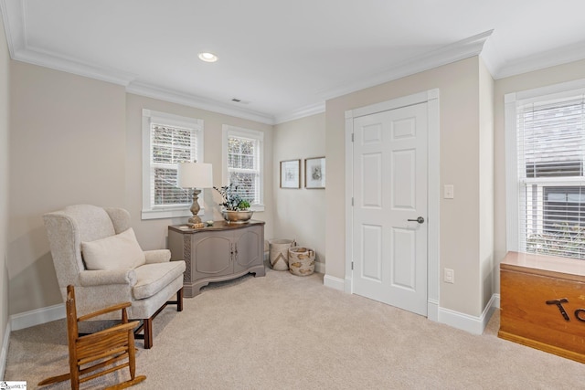 sitting room featuring light carpet and crown molding