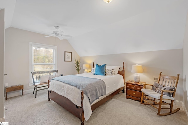 bedroom featuring light colored carpet, vaulted ceiling, and ceiling fan