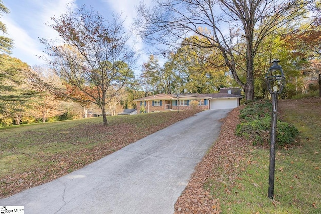 ranch-style house with a garage and a front yard