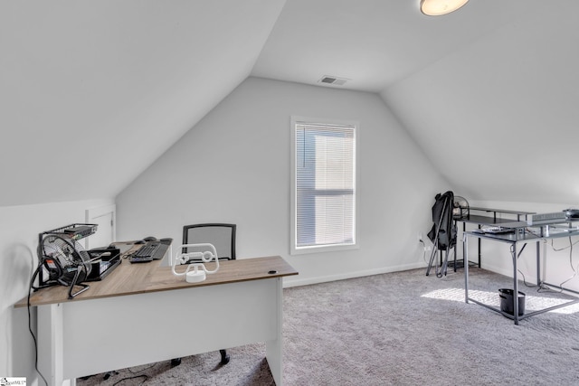 carpeted office space featuring lofted ceiling