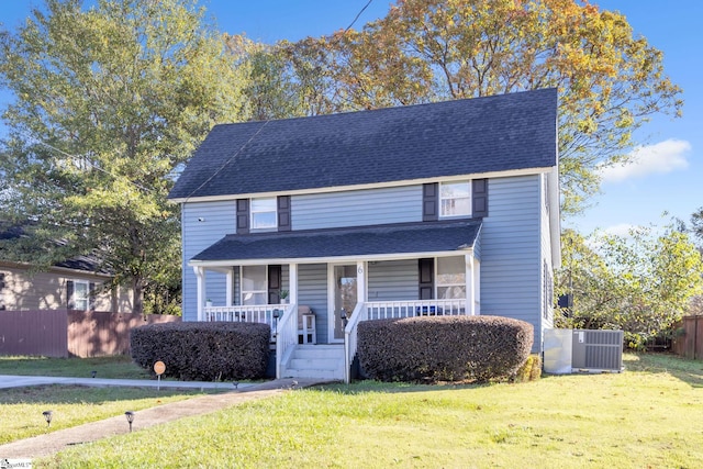 view of front of house with a porch, central AC, and a front lawn