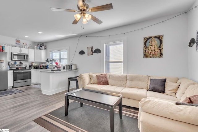 living room with hardwood / wood-style flooring and ceiling fan