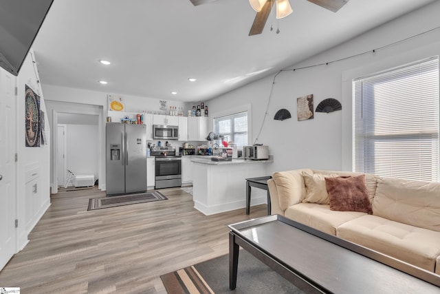 living room featuring ceiling fan and light wood-type flooring