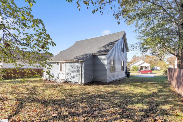 view of side of property with a yard