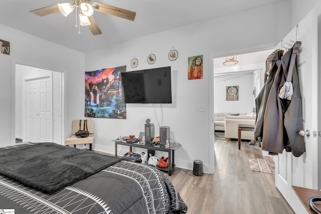 bedroom featuring ceiling fan, wood-type flooring, and a closet