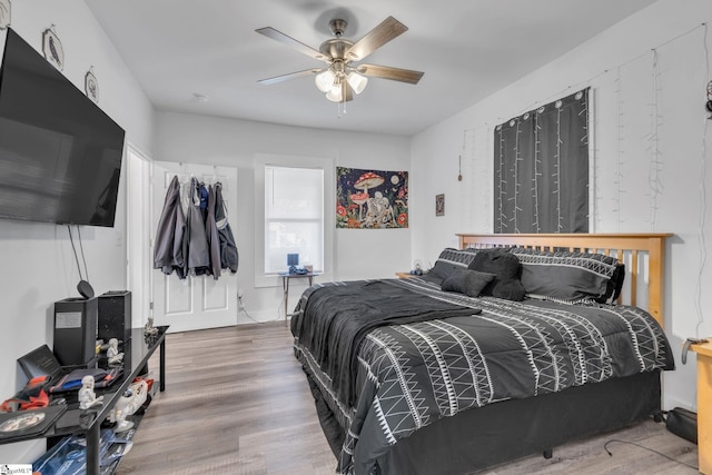 bedroom with hardwood / wood-style floors and ceiling fan