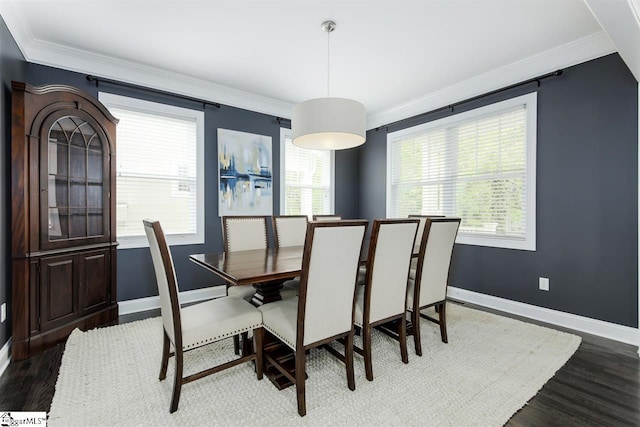 dining room with dark wood-type flooring and ornamental molding