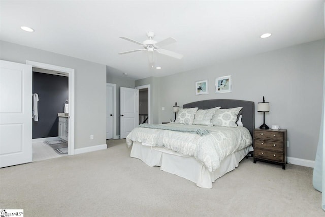 bedroom featuring ceiling fan, light carpet, and connected bathroom