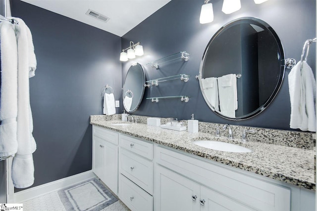 bathroom with tile patterned flooring and vanity