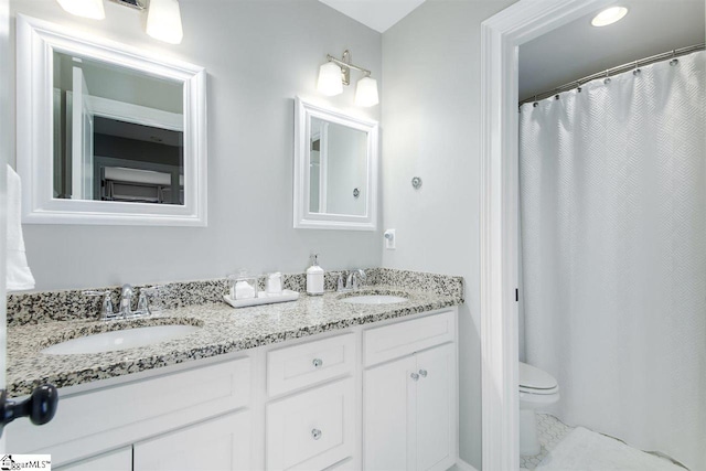 bathroom with vanity, toilet, and walk in shower