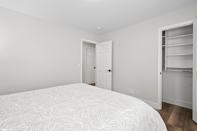 bedroom with a closet and dark wood-type flooring