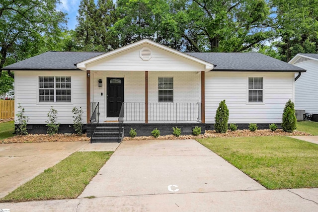 ranch-style home with a front yard, a porch, and central AC