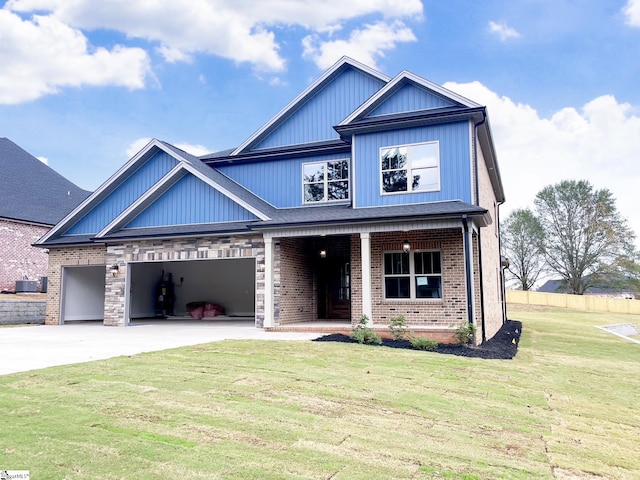 craftsman inspired home with cooling unit, a garage, a front yard, and covered porch