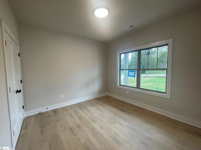 unfurnished room with light hardwood / wood-style flooring