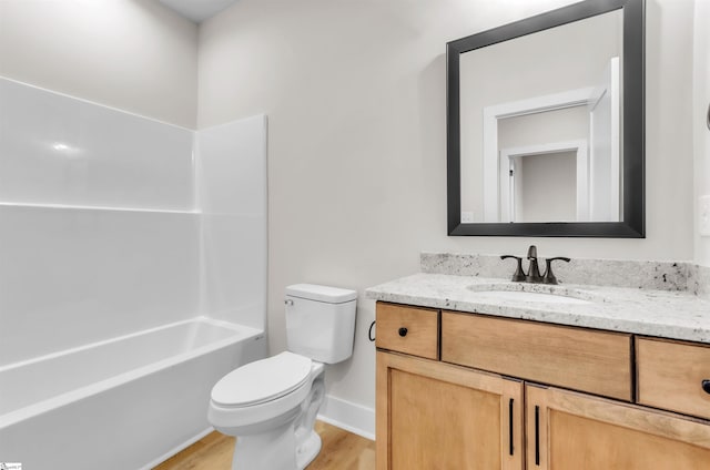 full bathroom featuring hardwood / wood-style flooring, vanity, toilet, and bathing tub / shower combination