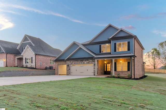 craftsman inspired home featuring a yard and central air condition unit