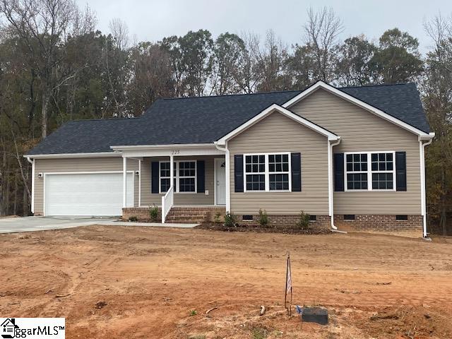 single story home featuring covered porch and a garage