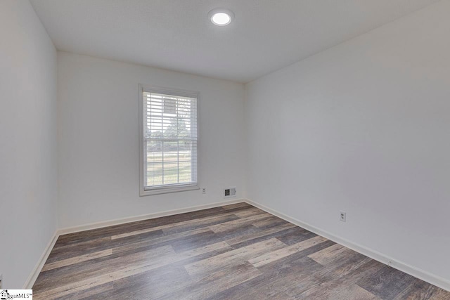 spare room featuring dark hardwood / wood-style flooring