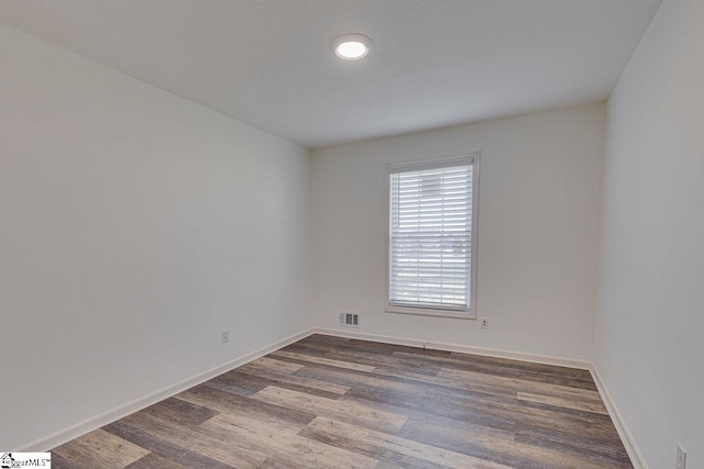 empty room featuring hardwood / wood-style flooring