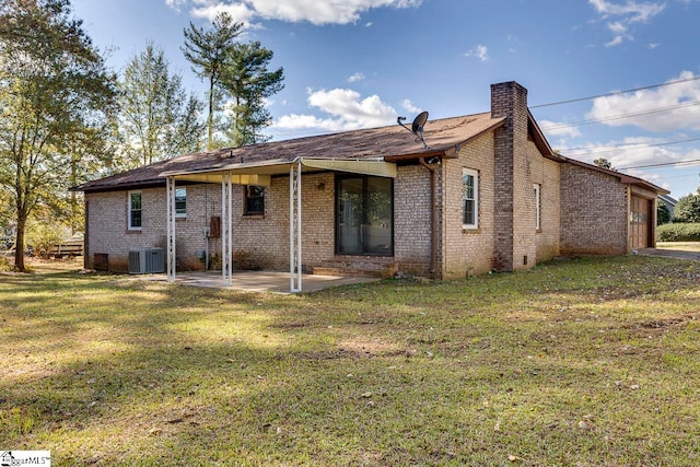 rear view of house with a lawn and a patio area