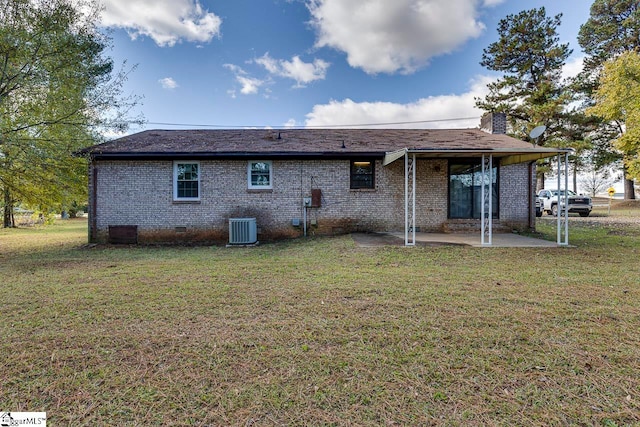 back of house with a yard, central AC unit, and a patio area