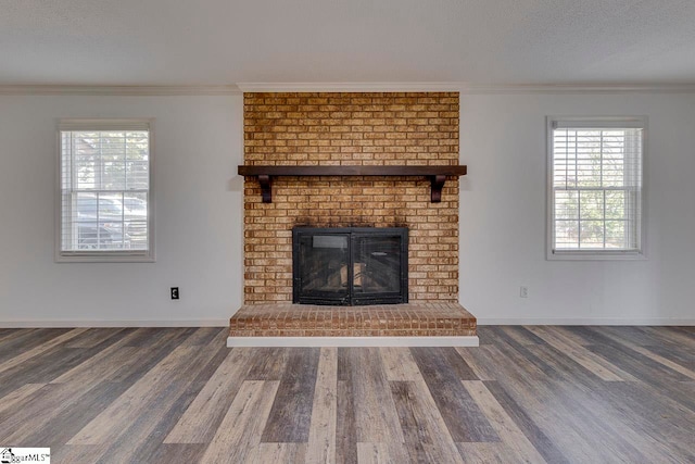 unfurnished living room with a fireplace, dark hardwood / wood-style flooring, and ornamental molding