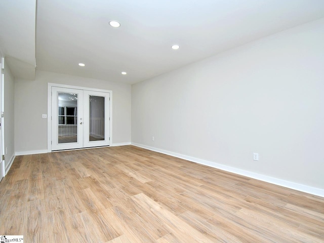 empty room with light hardwood / wood-style flooring and french doors