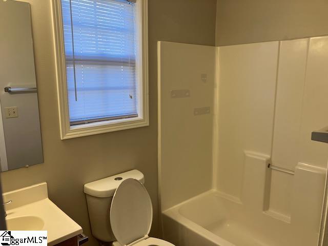 full bathroom with vanity, toilet, and shower / tub combination