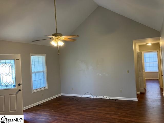 foyer entrance featuring ceiling fan, dark hardwood / wood-style floors, a healthy amount of sunlight, and high vaulted ceiling