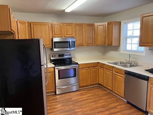 kitchen featuring sink, dark wood-type flooring, and appliances with stainless steel finishes