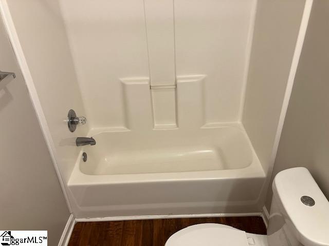 bathroom with hardwood / wood-style floors and toilet