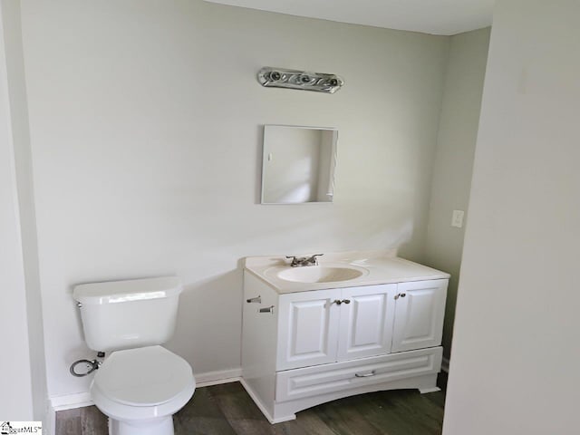 bathroom featuring hardwood / wood-style floors, vanity, and toilet