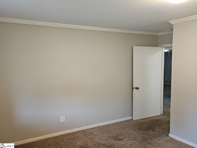 carpeted empty room featuring crown molding