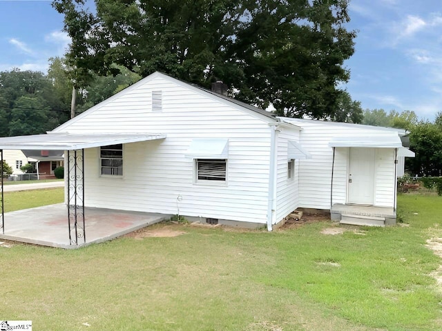 rear view of property with a patio area and a yard