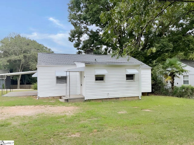 back of house with a yard