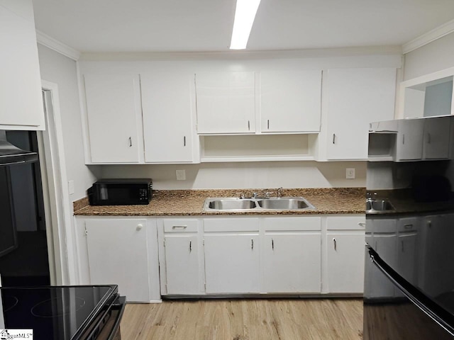 kitchen with light wood-type flooring, crown molding, black appliances, sink, and white cabinetry