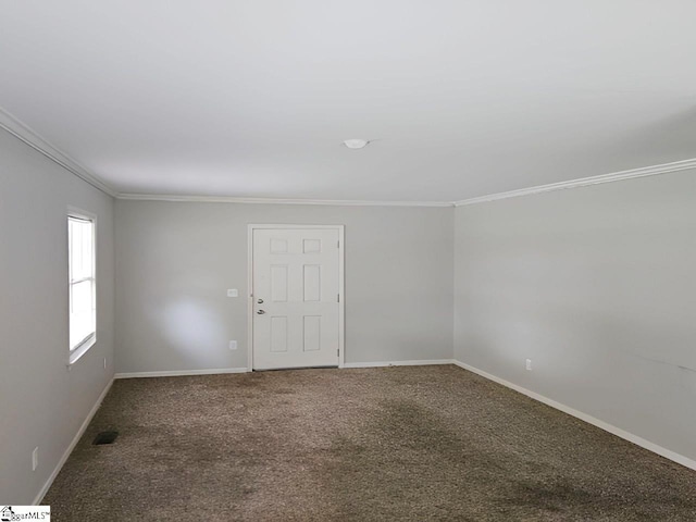 carpeted spare room with crown molding