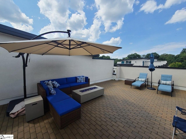 view of patio / terrace featuring an outdoor living space with a fire pit