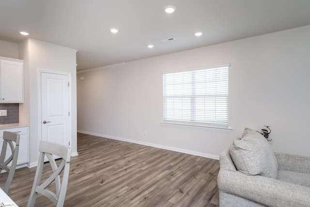 sitting room featuring hardwood / wood-style flooring and ornamental molding