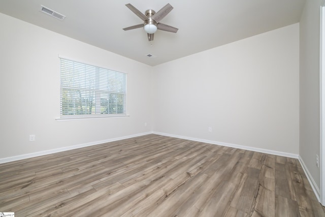 empty room featuring ceiling fan and light hardwood / wood-style floors